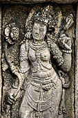 Prambanan, apsara flanking Hindu deity  on relief panel on the wall of Vishnu temple. 